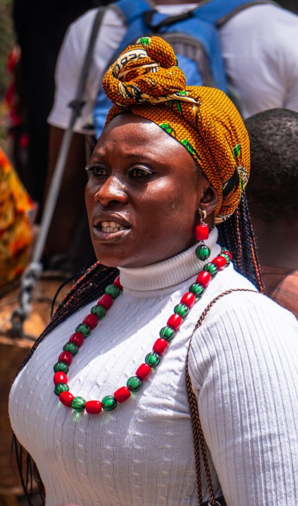 Home Portrait of a woman in traditional attire with colorful beads and a head wrap, showcasing cultural heritage.